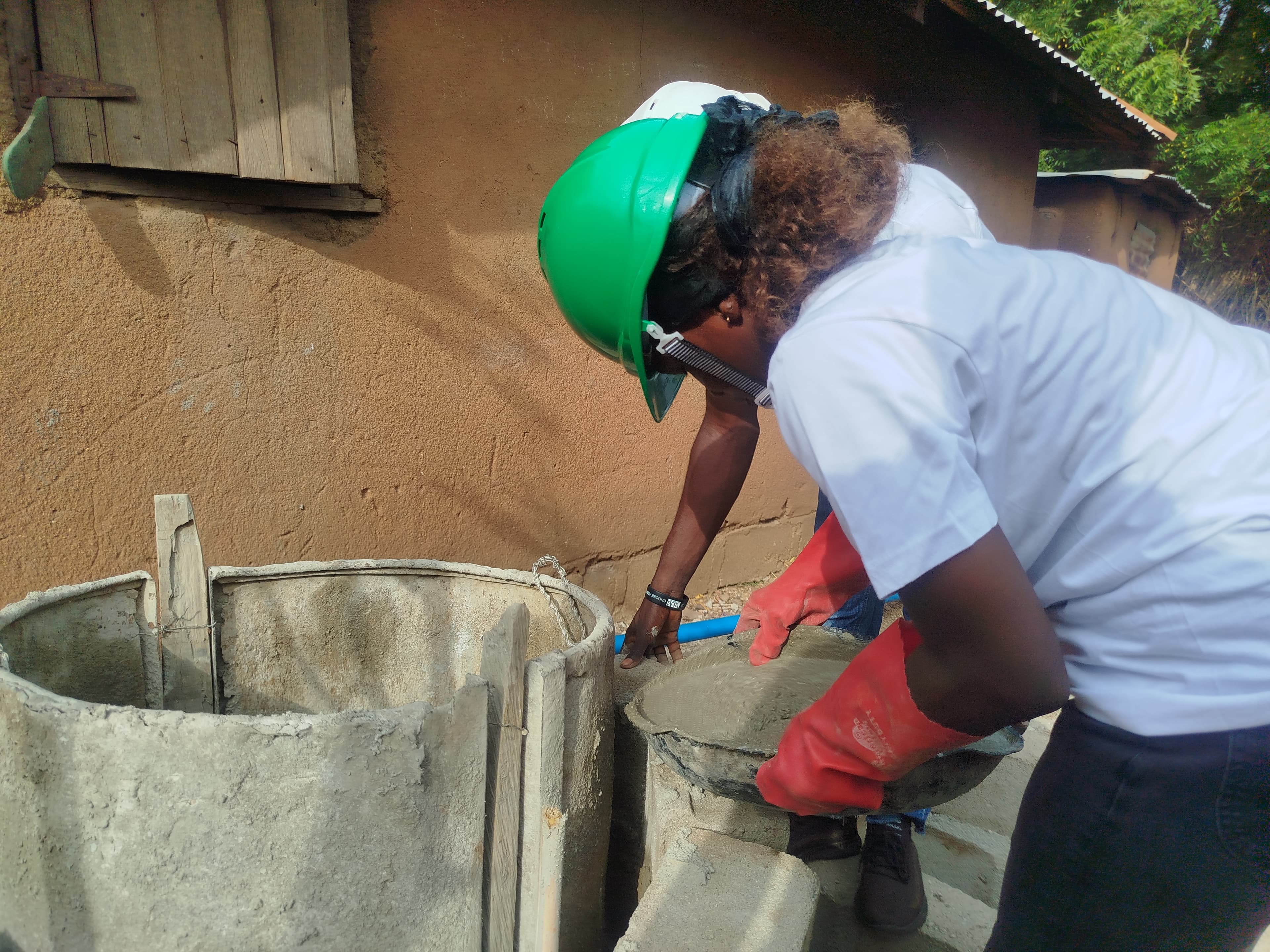 Worker building a Spark365 biodigester